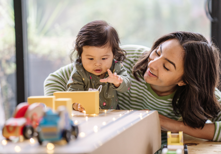toddler playing with mom