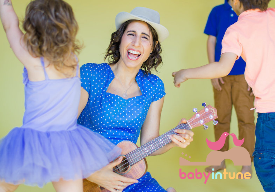 Musician, Vered singing and playing guitar with preschool children