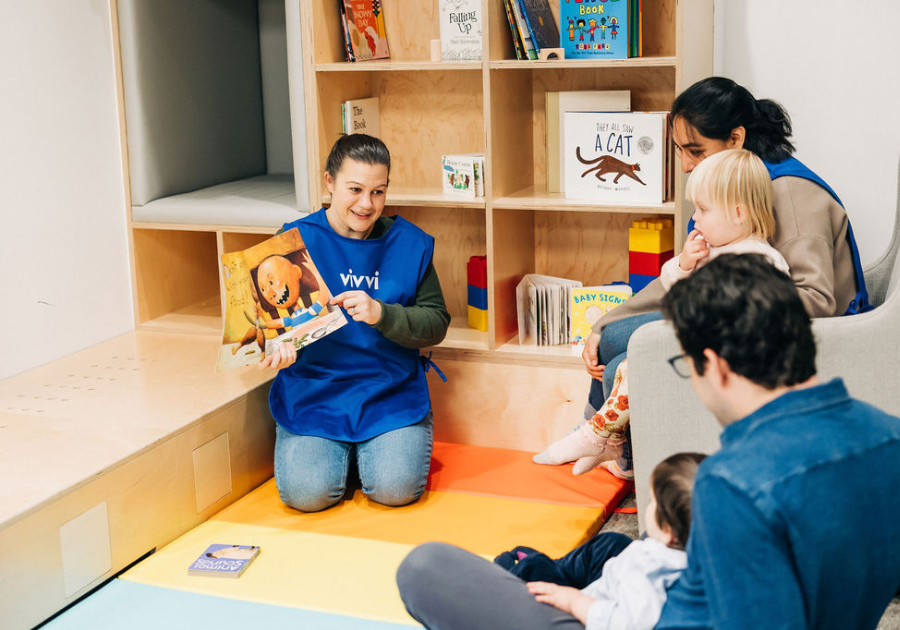 preschool teacher reading a story to children and parents preschool teacher reading a story to children and parents
